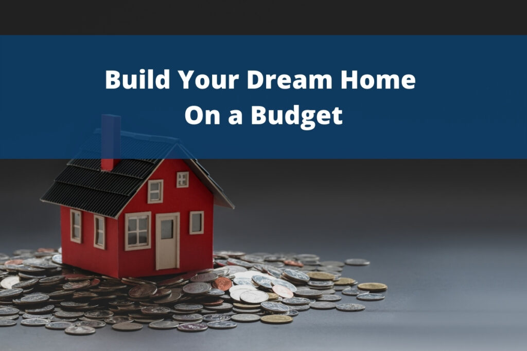 "A small red model house placed on a pile of coins with the text 'Build Your Dream Home On a Budget' displayed on a blue banner, symbolising affordable home construction and cost-effective building solutions."